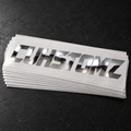 Display stack of chrome CUHSTOMZ decals; sold individually