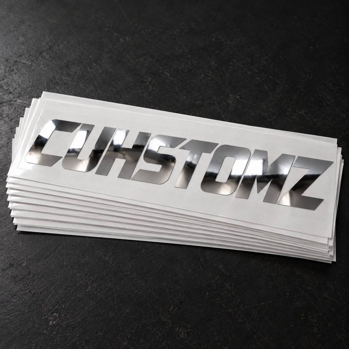 Display stack of chrome CUHSTOMZ decals; sold individually